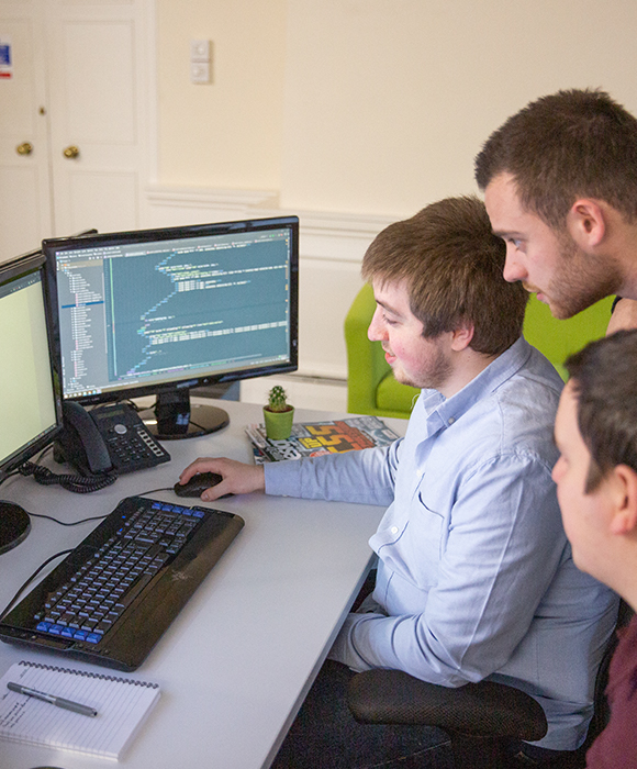 A group of developers viewing code together