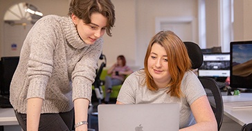 Developer and designer working together at a laptop