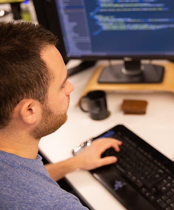 Web developer coding at desk