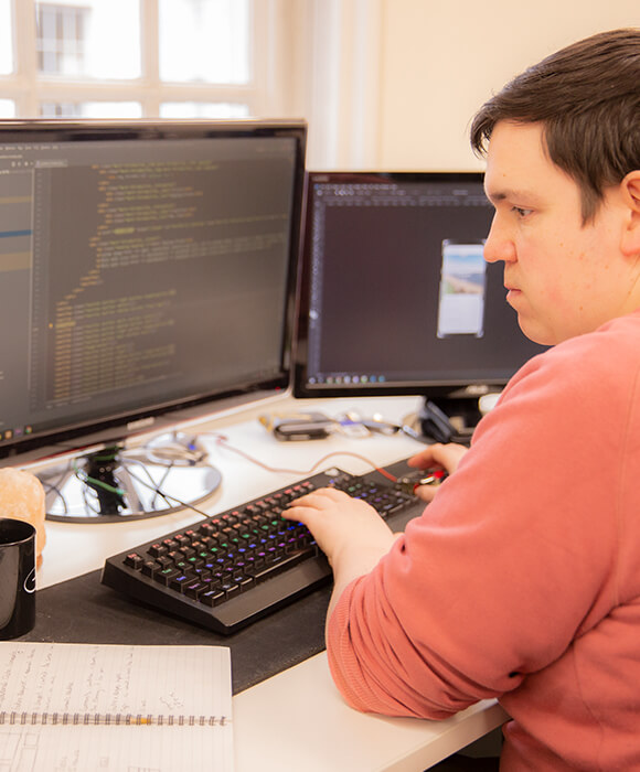 Front end developer coding at a desk