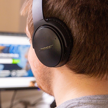 Developer working at desk with headphones on
